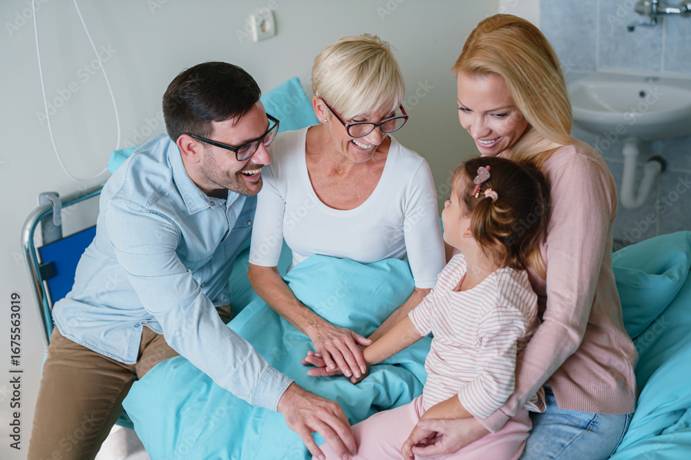 Fototapeta premium Sweet Caucasian Family Visiting Grandmother in a Hospital Room Sharing Laughter and Love Together