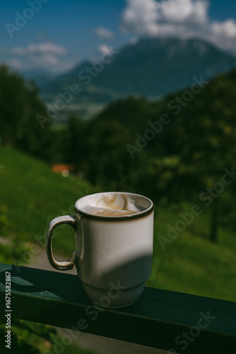 A warm cup of creamy cappuccino enjoyed in the quiet morning mountains — soft foam, rich aroma, and breathtaking views in Alps Mountains create the perfect start to inspiring day