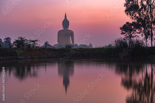 Slika na platnu reflection of the biggest Buddha in the swamp at sunrise