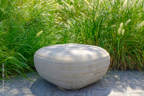 Stone round bench on the grass