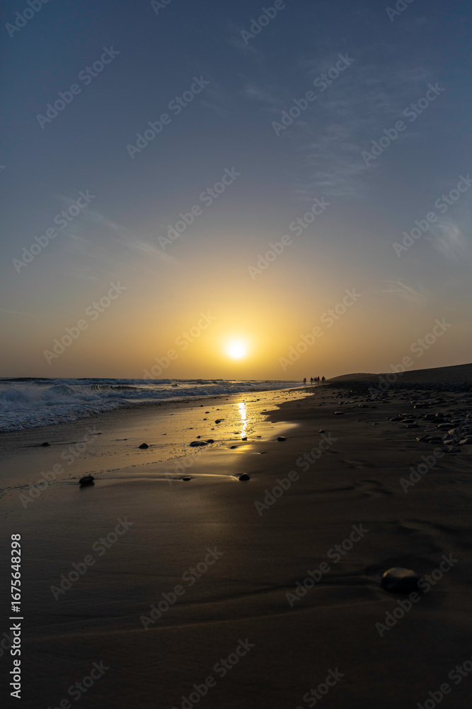 Fototapeta premium Sunset view from the beach of Maspalomas in a clear sky, in Gran Canaria Spain.