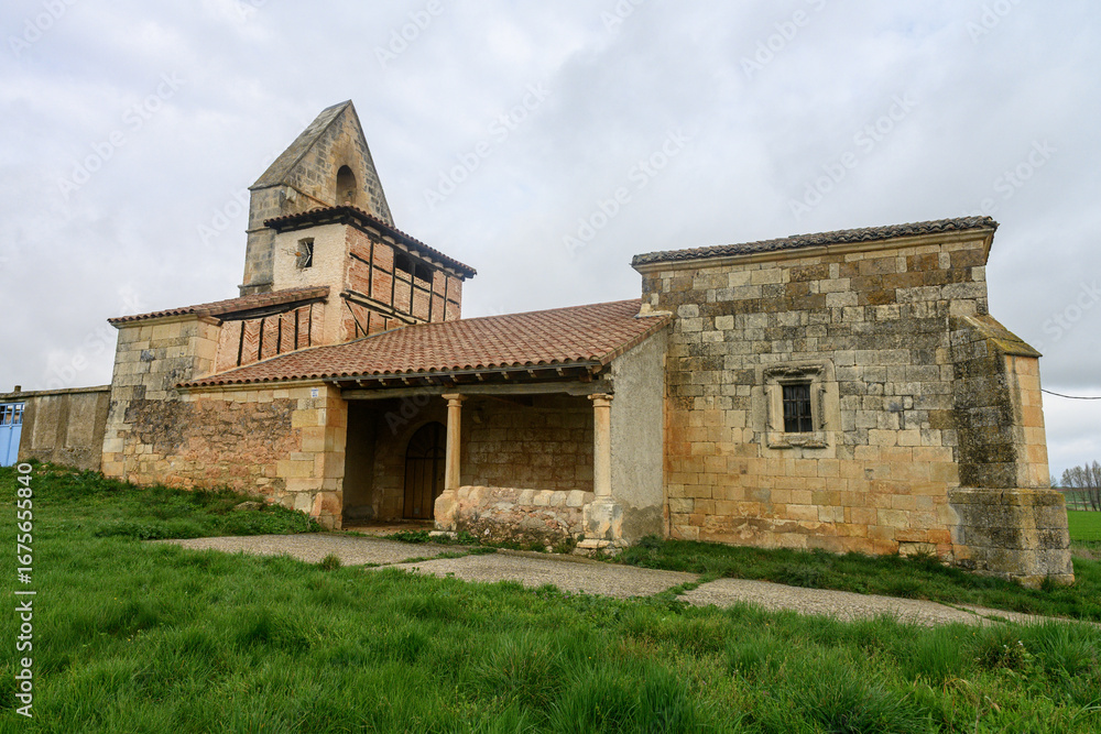 Fototapeta premium Historic Church of San Miguel with stone walls and bell gable in Villavega de Ojeda