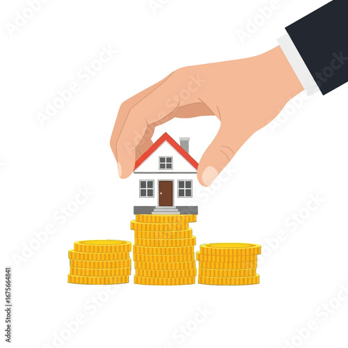 A hand places a small house atop a stack of gold coins, symbolizing the purchase of property with financial resources.