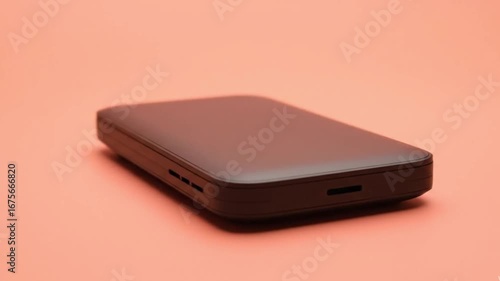 Cinematic Product Shot of a Small Black Electronic Device Rotating

