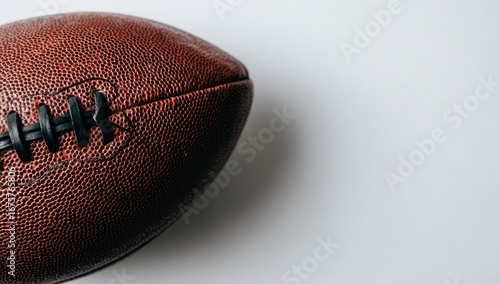 Close-up of a football, leather-covered, dark brown, on a plain white background