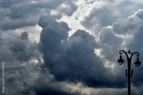 street lamp against cloudy sky