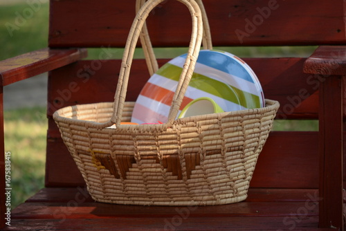 Weaved bosket with colorful plates Already for an outdoor picnic.