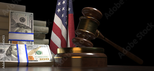 Foto A wooden gavel and a stack of hundred American dollar banknotes rest on a table in front of a red, white, and blue flag with stars and stripes, depicting the United States of America