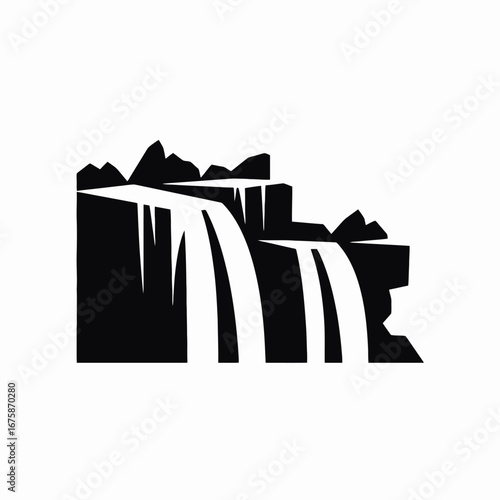 Majestic waterfall cascades down rocky terrain, showcasing natural beauty in silhouette.