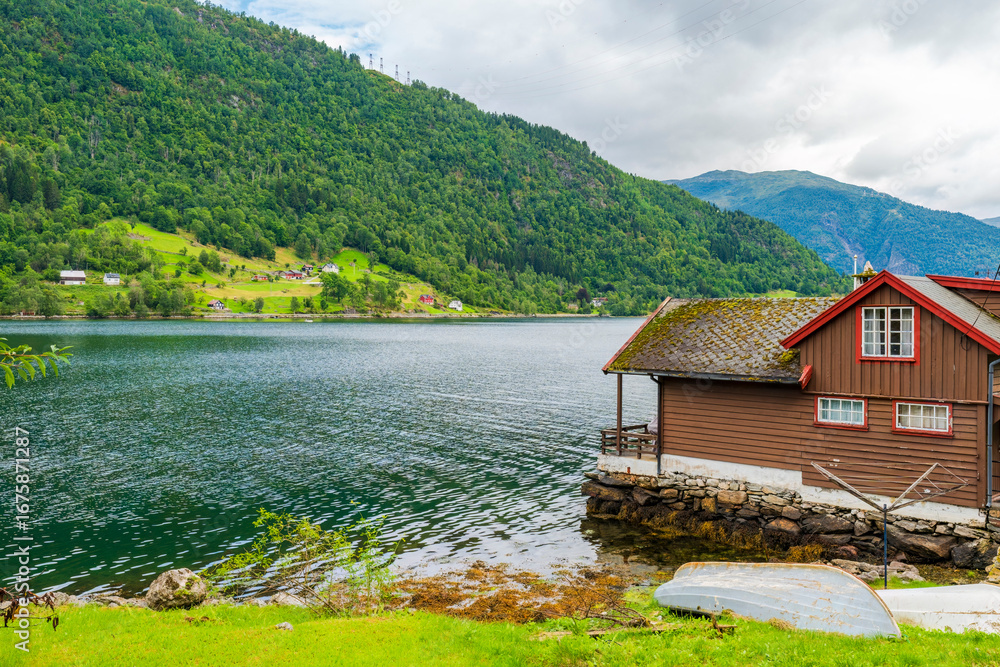 Fototapeta premium Traditional wooden house on the shore the Sognefjord in Balestrand, Norway