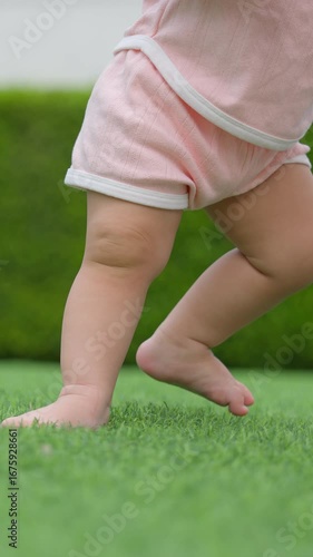 11-month-old baby learns to walk on grass, creating age-appropriate development