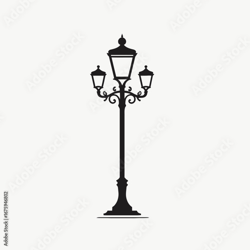 Elegant streetlight with ornate design against white backdrop, classic street silhouette