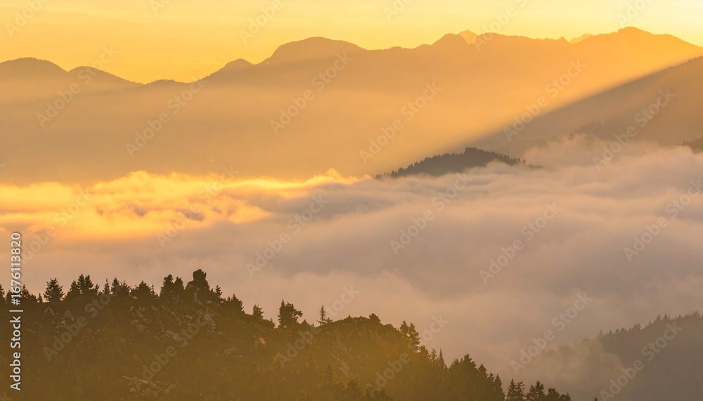 Obraz premium A tranquil and majestic view of a mountain range enveloped in a sea of fog during a golden sunrise, with stunning sunbeams piercing the haze