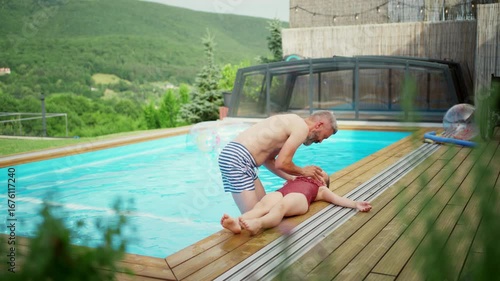 Father saving daughter after pool accident.