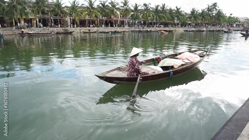 A person rowing a boat on the river, Hoi An Ancient Town, Quang Nam Province, Vietnam Travel