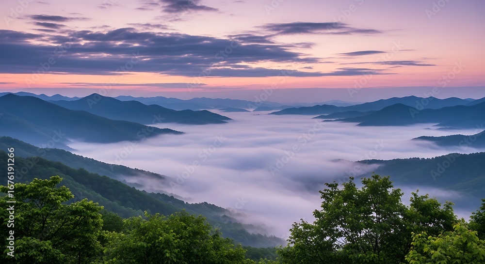 Obraz premium Serene mountain valley sunrise with fog and colorful sky over rolling hills