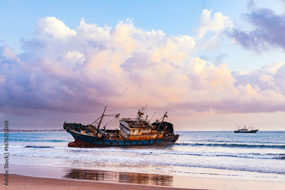 Fototapeta premium Butwani bridge and Malindi Pier area is a popular waterfront location known for stunning sunrises over the Indian Ocean. The pier is a concrete jetty that stretches about 400 meters into the ocean and