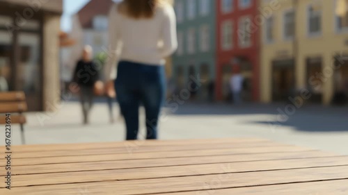Woman taking coffee cup from table outdoors in city street