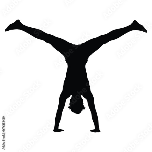 Man performing a handstand with legs spread wide in silhouette