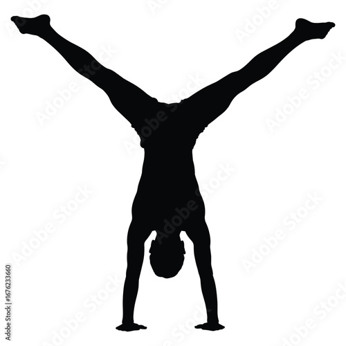 Athlete performing a handstand with legs spread wide in silhouette