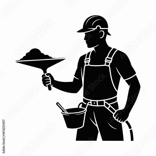 Construction worker holding a trowel with building material and a bucket