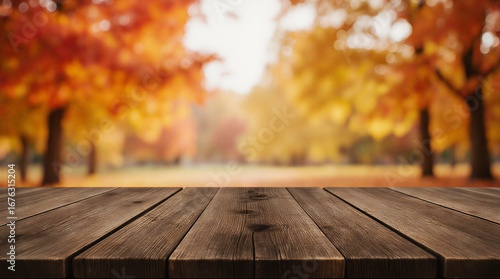 Fototapeta Naklejka Na Ścianę i Meble -  empty dark halloween wood table for product display with bright fall foliage backdrop | product display, seasonal, holiday, background, photography theme