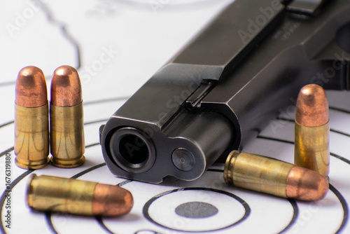 Handgun 9mm and Ammunition Displayed on Shooting Targets