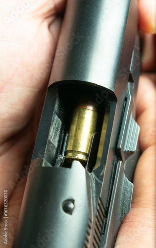 Close-Up of Bullet Positioned in a Handgun Chamber