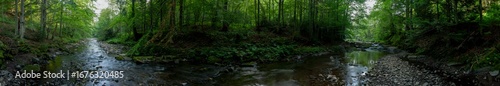 Panorama with a river in the mountains on a summer day. The wonderful coolness of the weekend attracts friends for a pleasant rest.