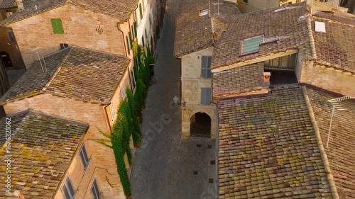 Overhead view of a charming historic European town street with traditional terracotta tiled roofs and ancient architecture