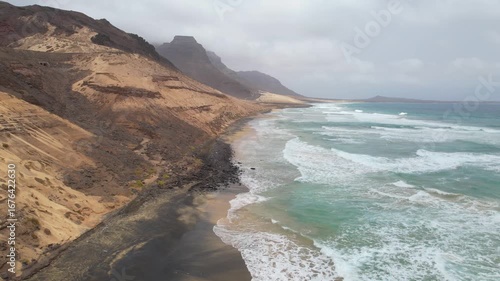 CAPE VERDE - 8.20.2025 - Stunning aerial footage moving up the coast of Sao Vicente, Cape Verde as waves lap the shore.