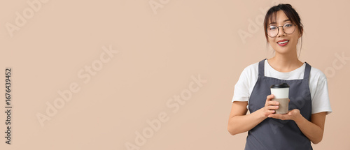 Female barista with cup of ...