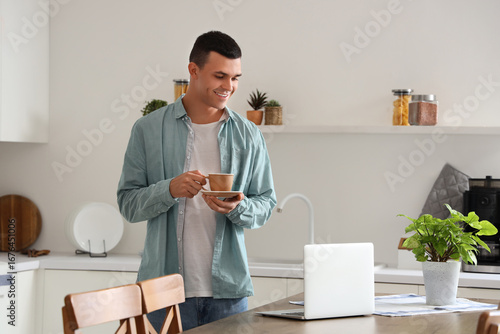 Handsome young man with cup...