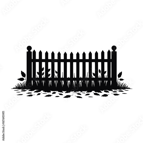 Silhouette of a picket fence with grass and falling leaves creates a charming outdoor scene