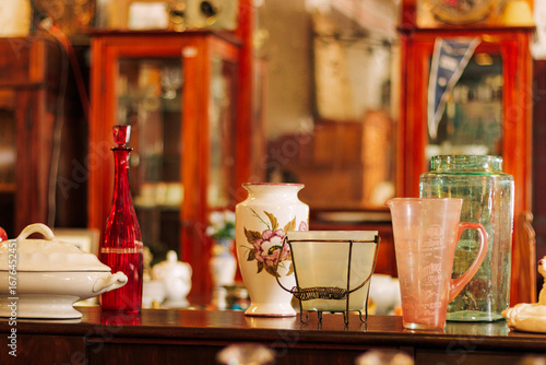 Colorful kitchen and shelf displaying antique-style dishes
