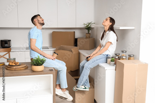 Tired young couple with cof...