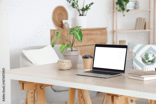 Blank laptop with coffee cu...