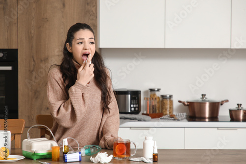 Ill young woman spraying he...