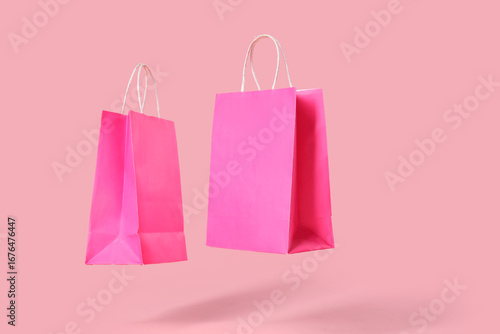 Pink shopping bags on color...