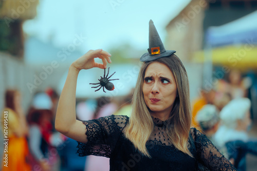Fotografie Woman in Witch Costume Holding a Spider