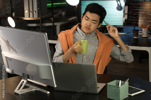Thoughtful male Asian progr...