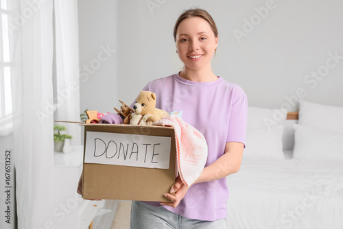 Young woman with box of toy...