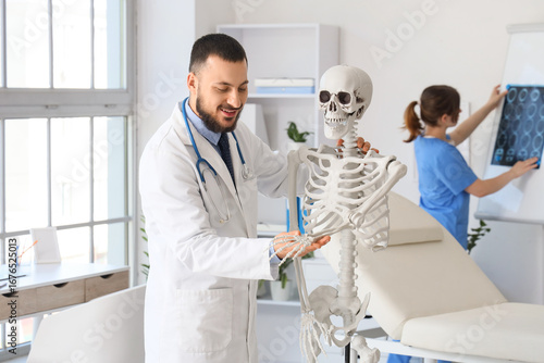 Smiling male doctor explain...