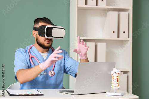 Male doctor using VR glasse...