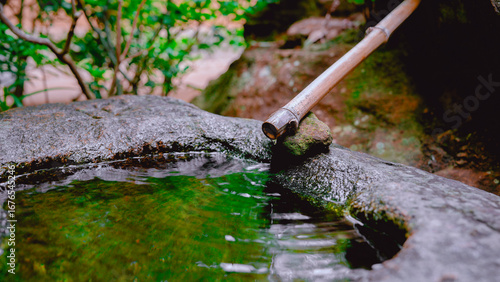 Traditional Bamboo Water Spout in Japanese Garden