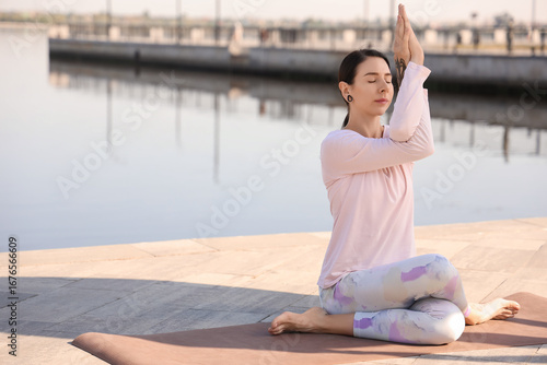 Young woman practicing yoga...