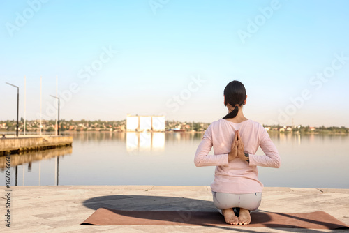Woman practicing yoga in re...