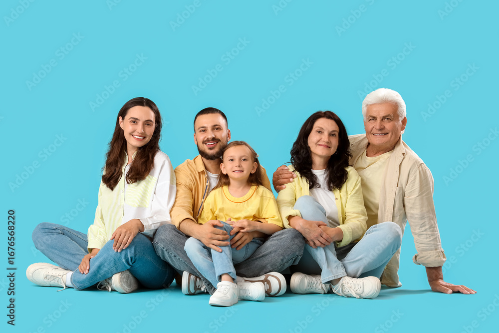 Fototapeta premium Portrait of big family sitting on blue background