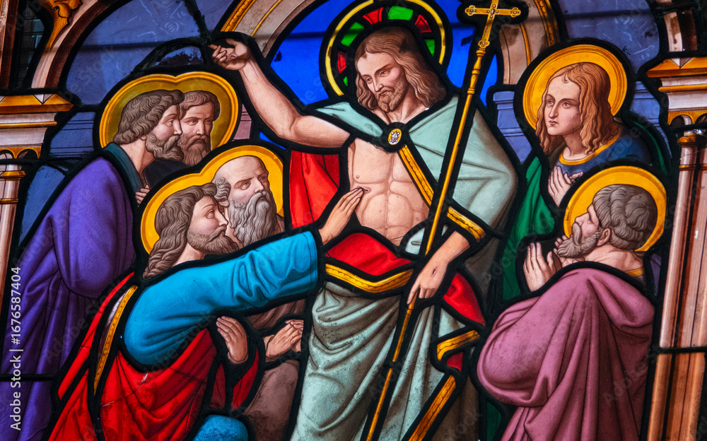 Fototapeta premium Stained (19th century) glass of Saint Thomas the Apostle touching the wounds of Christ.