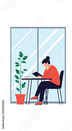 Woman reading a book at a table next to a tall plant in a bright room with large windows